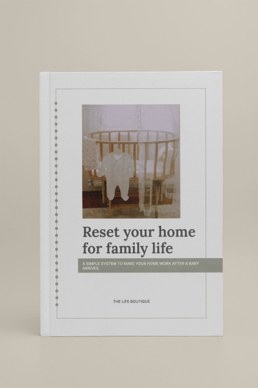Book titled 'Reset your home for family life' by The Life Boutique on a beige background
