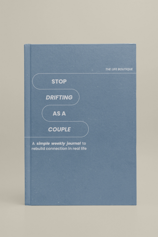 Blue journal titled 'Stop Drifting as a Couple' on a beige background